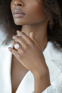 Diamond jewelry in white outfit model African American lady hand adult ring accessories.