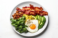 Keto friendly low carb breakfast plate with sunny side up eggs spinach avocado bacon.