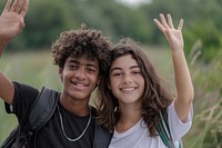 Two diversity cool teens waving smile togetherness accessories.