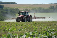 Tractor spraying pesticides tractor field agriculture.
