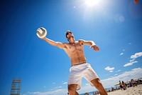 Beach volleyball player in action at sunny day under blue sky sports shorts beach.