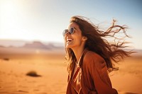 Woman standing at desert laughing outdoors smile.