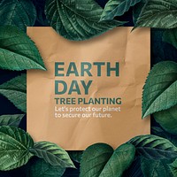 Earth day crumpled paper poster with leafy frame flat lay