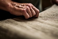 Hand doing Upholstery workshop finger flooring darkness.