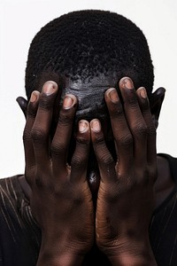 Depressed young black man hiding head in hands frustration distraught portrait.