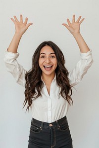 Excited latina woman raised her hands up blouse smile white background.