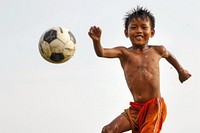 Thai boy playing soccer football sports child.