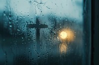 Cross doodle silhouette window glass rain.