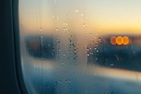 Steamed fogged inside airplane window vehicle glass sky.