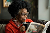 Black woman drinking black coffee photography reading accessories.