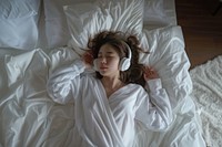 Woman wearing a headphone headphones electronics blanket.