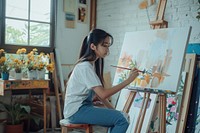 Thai teenager painting canvas illustrated furniture.