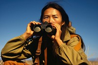 Woman using Binoculars binoculars photo photography.