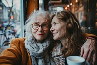 Senior mother and daughter laughing portrait glasses.