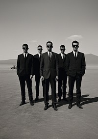 Four man wearing black suit and black sunglasses photography transportation accessories.