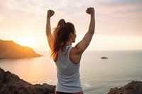 Happy woman stretch arms after workout beach determination achievement.