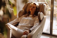 Woman sitting at electric massage chair adult contemplation spirituality.