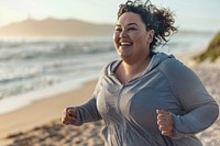 Happy chubby woman jogging by the beach laughing smile adult.