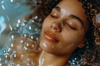 Relaxed woman in bubble bathtub relaxation medication hairstyle.