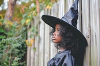 Girl dressed as a witch adult architecture celebration.