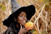Girl dressed as a witch halloween adult jack-o-lantern.
