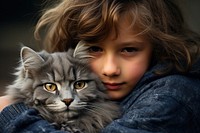 A kid cuddle with a grey cat portrait mammal animal.
