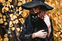 Woman dressed as a witch portrait animal mammal.