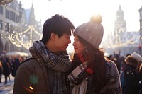 Asian couple travel to Germany at Marienplatz outdoors kissing adult.