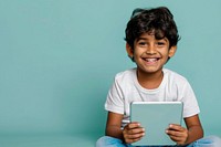 Indian kid reading the tablet happy electronics surprised.