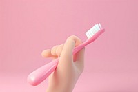 Hand holding toothbrush device tool.