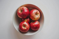 A bowl of apple produce fruit plant.