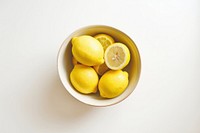 A bowl of lemon produce fruit plant.