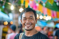 Thai man at a music festival happy dimples person.