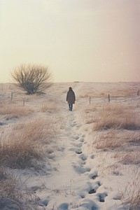 Woman walking in snow landscape photography outdoors.