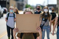 White teenager wear mask cardboard transportation electronics.