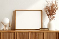 Blank framed photo mockup furniture sideboard indoors.