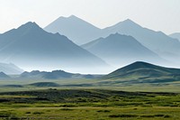 Photo of mountain range landscape grassland outdoors.