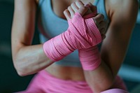 Wrapping hands with pink boxing wraps exercising relaxation stretching.