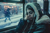 Women sitting traveling on the subway in winter time vehicle adult photo.