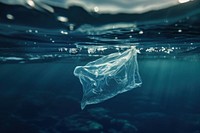 Closeup a plastic bag floating half under the sea transparent underwater undersea.