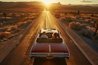 Couple driving vehicle sunset desert.