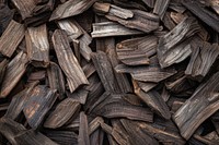 Premium dark Agarwood Chips backgrounds abundance textured.