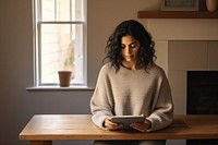 Young woman using tablet sitting contemplation concentration.