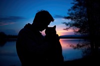 Cat hugging silhouette photography backlighting outdoors portrait.