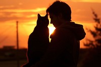 Cat hugging silhouette photography backlighting outdoors sunrise.