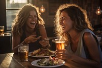 Two happy female having meal and beer and laughing drink plate adult.