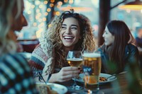 Happy female friends having meal and beer and laughing drink party adult.