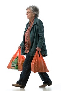 Full length profile shot of a mature woman carrying grocery bags handbag walking adult.