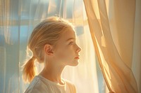 A girl standing at window side blonde person human.