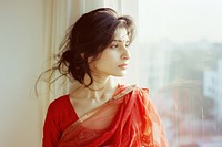 An indian woman portrait standing at window side person female human.